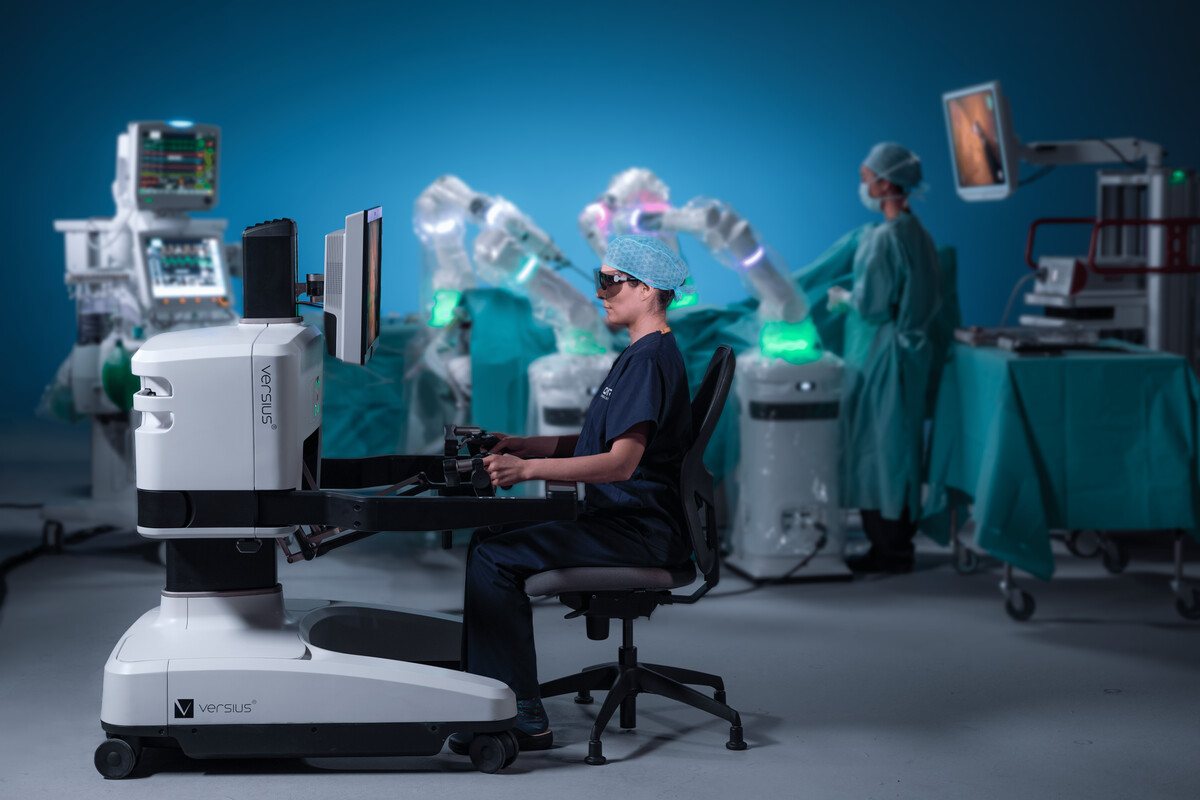 Surgeon sits at the Versius surgical robotic system to perform a minimally invasive procedure
